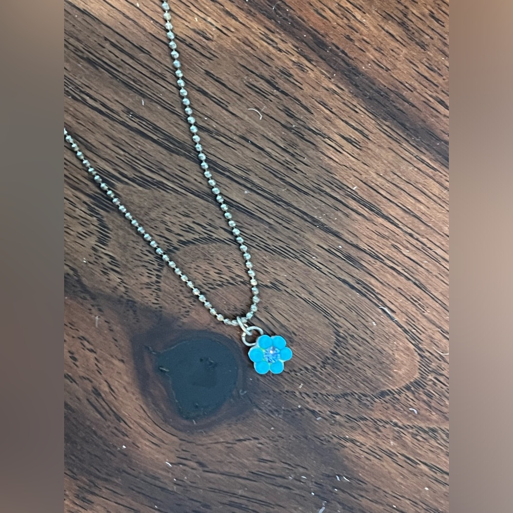 Dainty blue flower pendant necklace on a silver ball chain